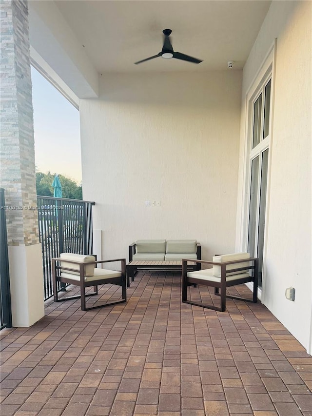 view of patio / terrace featuring a balcony, ceiling fan, and outdoor lounge area