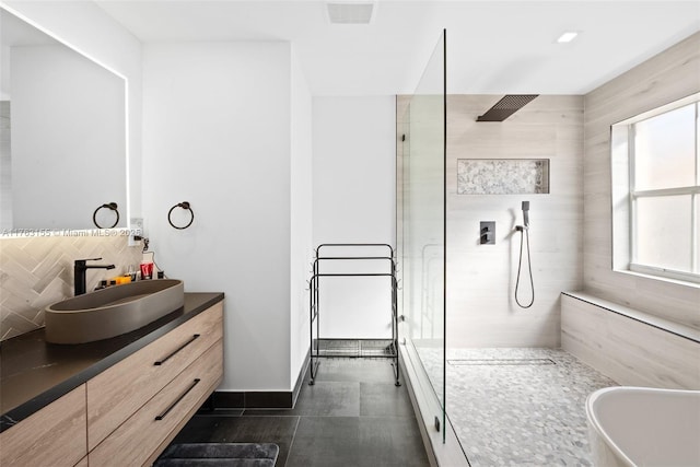 full bath featuring vanity, visible vents, a soaking tub, decorative backsplash, and a walk in shower