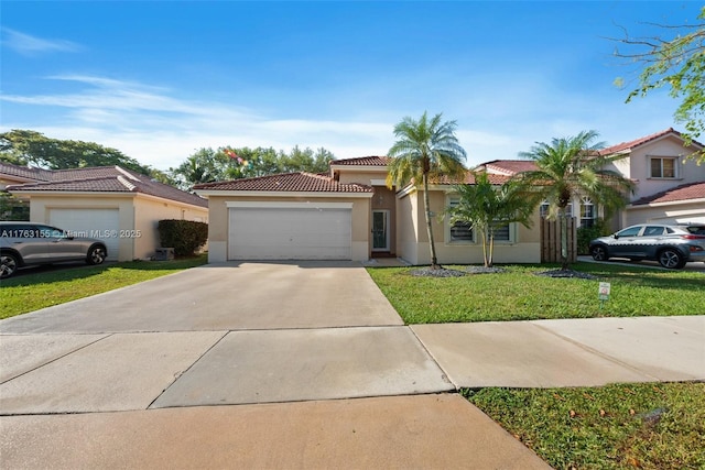 mediterranean / spanish house with a front yard, stucco siding, concrete driveway, a garage, and a tile roof