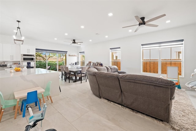 living area with a ceiling fan, light tile patterned flooring, and recessed lighting