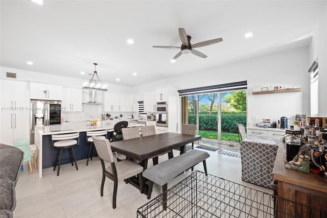 dining area featuring light tile patterned floors, visible vents, recessed lighting, and ceiling fan with notable chandelier