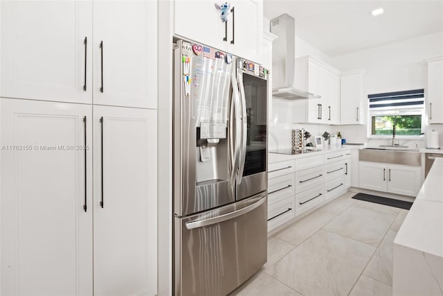 kitchen featuring stainless steel refrigerator with ice dispenser, white cabinetry, light countertops, light tile patterned floors, and extractor fan