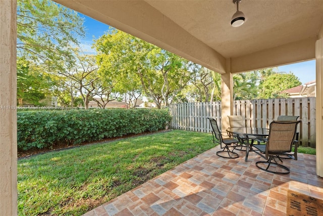 view of patio featuring outdoor dining area and a fenced backyard