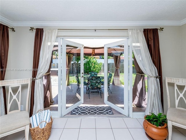 doorway featuring tile patterned floors, a textured ceiling, and crown molding