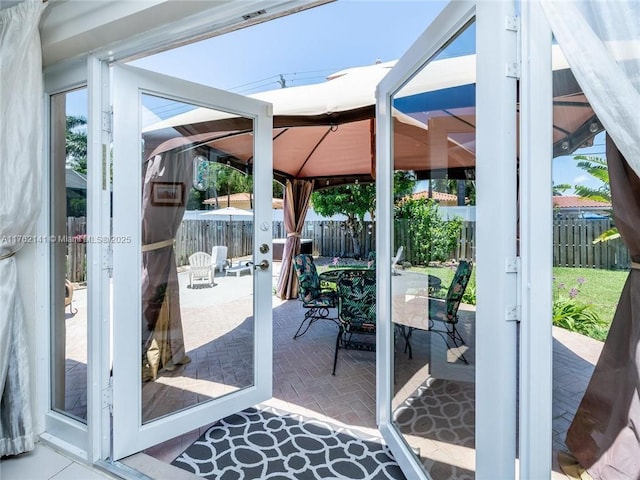 doorway featuring brick floor and a sunroom