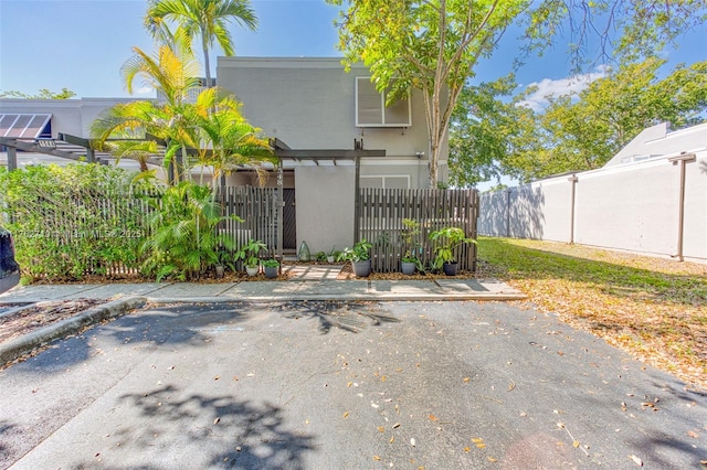 view of gate with a fenced front yard