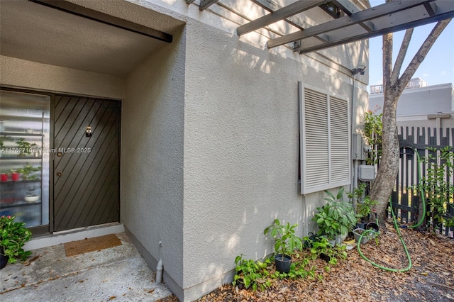 1548 NW 113th Way, Pembroke Pines, FL 33026 - property entrance with fence, a pergola, and stucco siding