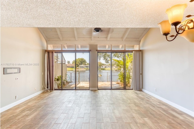 1548 NW 113th Way, Pembroke Pines, FL 33026 - spare room featuring a wealth of natural light, wood finished floors, and baseboards