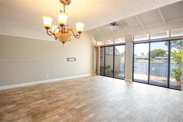 1548 NW 113th Way, Pembroke Pines, FL 33026 - spare room with a wealth of natural light, wood finished floors, a chandelier, and baseboards
