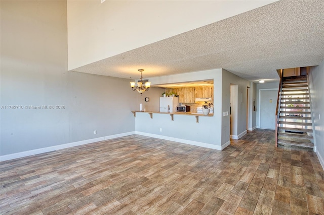 1548 NW 113th Way, Pembroke Pines, FL 33026 - kitchen with electric range, stainless steel microwave, under cabinet range hood, visible vents, and freestanding refrigerator
