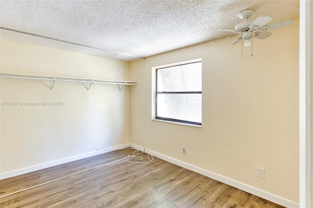 1548 NW 113th Way, Pembroke Pines, FL 33026 - bedroom featuring baseboards, a textured ceiling, and light wood-style flooring