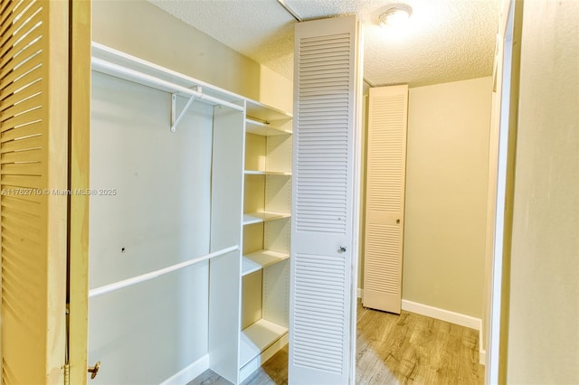 1548 NW 113th Way, Pembroke Pines, FL 33026 - empty room featuring visible vents, a ceiling fan, light wood-style floors, baseboards, and a textured ceiling