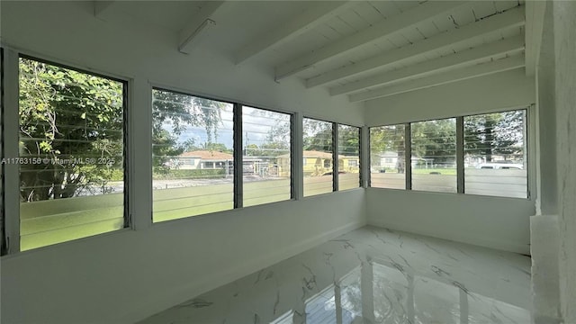 unfurnished sunroom with beamed ceiling