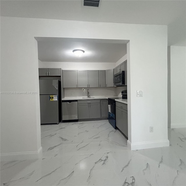 kitchen with marble finish floor, visible vents, appliances with stainless steel finishes, and gray cabinetry