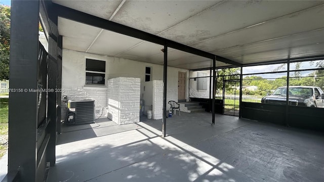 view of patio with central AC unit and an attached carport