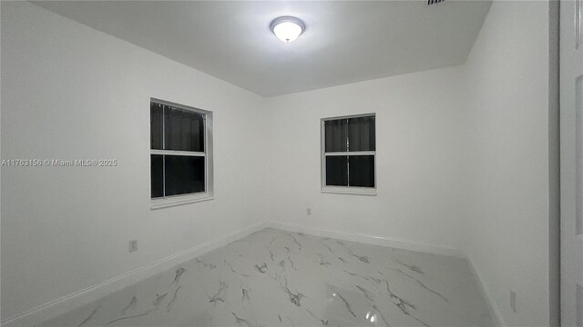 205 Seaman Ave, Opa-Locka, FL 33054 - empty room featuring baseboards and marble finish floor