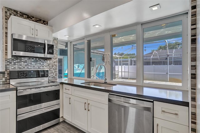 kitchen with dark countertops, appliances with stainless steel finishes, and a sink