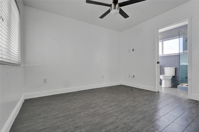 unfurnished room with dark wood-style floors, baseboards, and ceiling fan