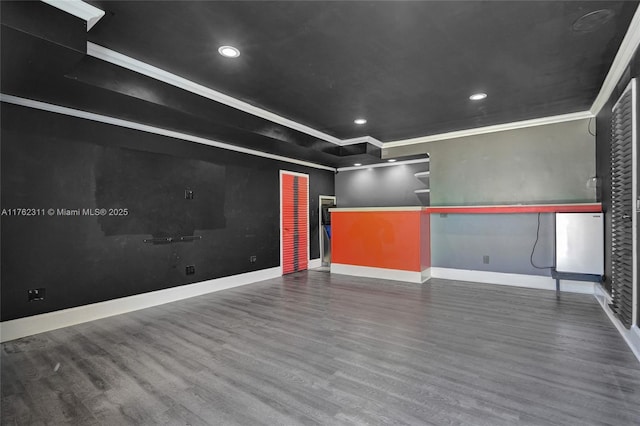 interior space featuring recessed lighting, wood finished floors, baseboards, and ornamental molding