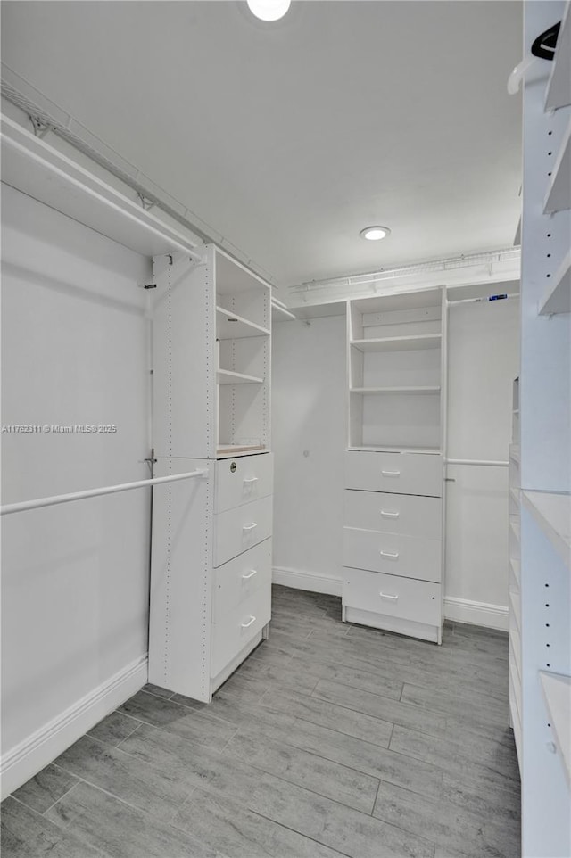 walk in closet featuring light wood-style floors