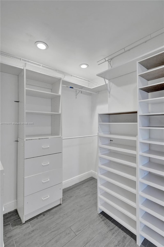 spacious closet with wood finished floors