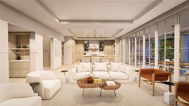 living room with light wood finished floors and a tray ceiling