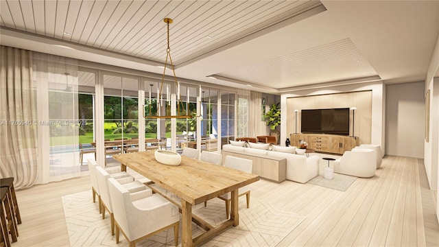 dining area featuring wood ceiling, light wood-type flooring, and a tray ceiling