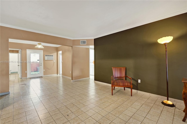 living area featuring visible vents, a wall unit AC, crown molding, light tile patterned floors, and baseboards