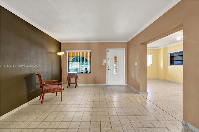 foyer featuring crown molding, light tile patterned flooring, and baseboards