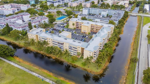 birds eye view of property featuring a water view and a city view