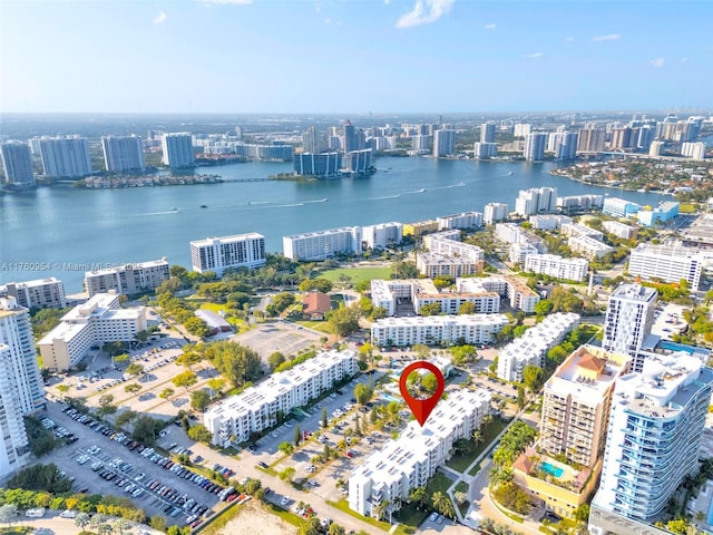 drone / aerial view with a city view and a water view