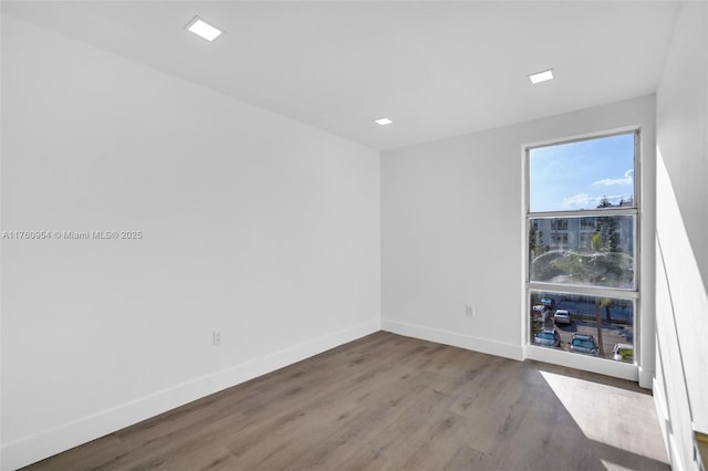 empty room with wood finished floors and baseboards