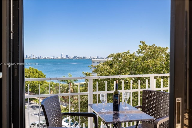 balcony with a view of city and a water view