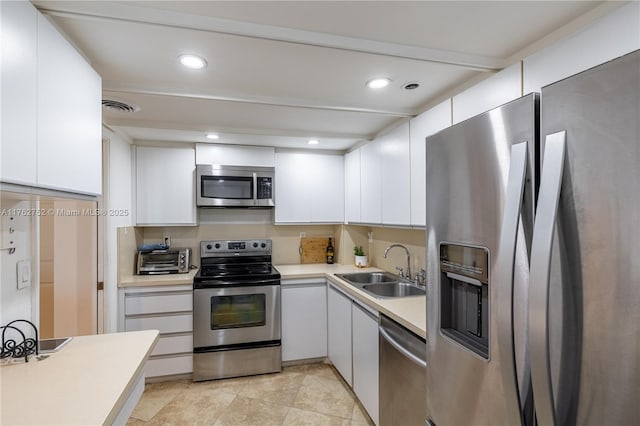 4000 Towerside Ter Unit 610, Miami, FL 33138 - kitchen featuring white cabinets, visible vents, stainless steel appliances, and a sink