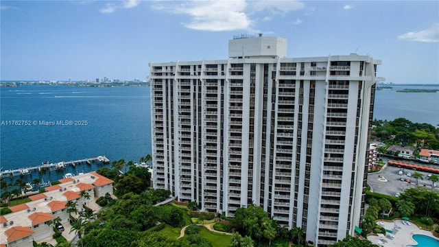 view of building exterior featuring a water view and a view of city