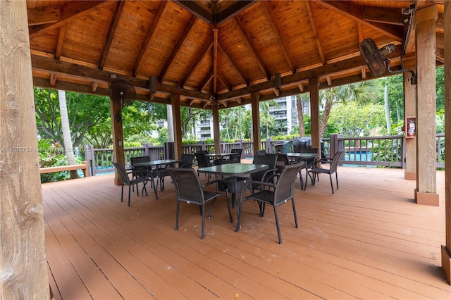 deck featuring a gazebo and outdoor dining area