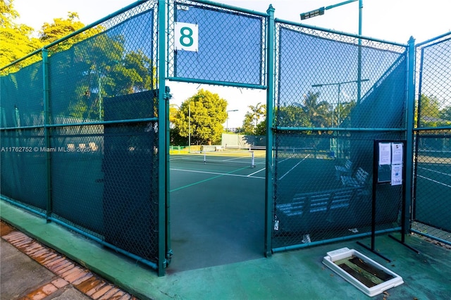 view of sport court with fence