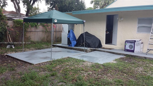 view of patio / terrace with a carport and fence