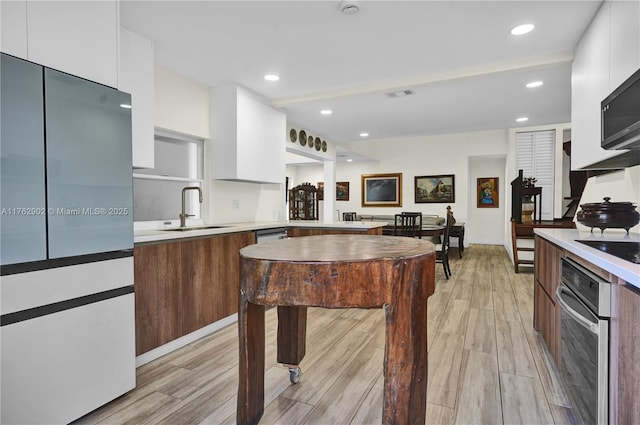 kitchen featuring white cabinetry, modern cabinets, stainless steel appliances, and a sink