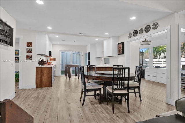 dining room with recessed lighting, light wood-style flooring, baseboards, and visible vents