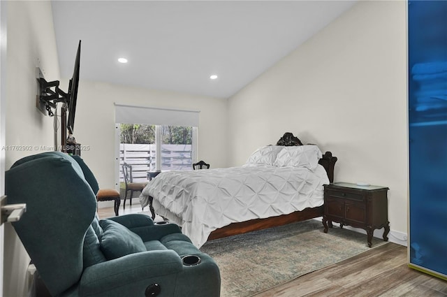 bedroom with vaulted ceiling, recessed lighting, wood finished floors, and baseboards