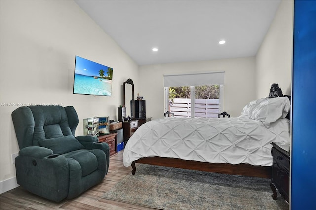 bedroom with recessed lighting and wood finished floors