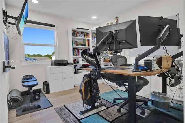 exercise area featuring recessed lighting and light wood-type flooring