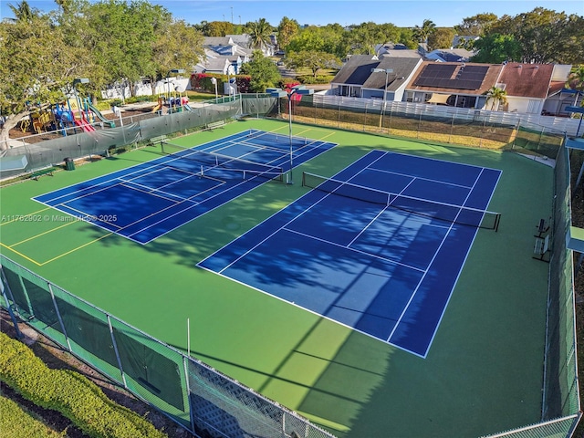 view of tennis court featuring fence