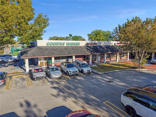 view of building exterior with uncovered parking