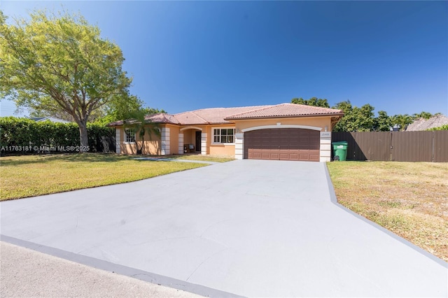 view of front facade featuring a front yard, fence, driveway, an attached garage, and a tiled roof