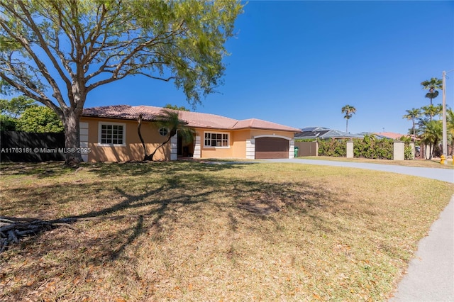 single story home featuring stucco siding, an attached garage, concrete driveway, and a front lawn