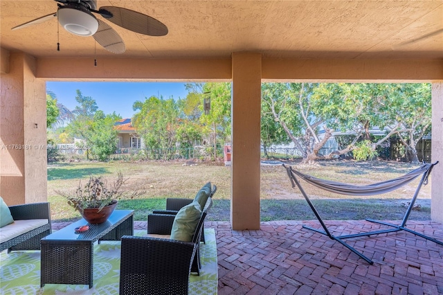 view of patio featuring an outdoor living space, a ceiling fan, and a fenced backyard