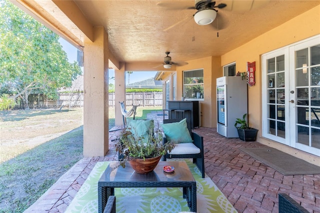 view of patio with french doors, ceiling fan, and fence