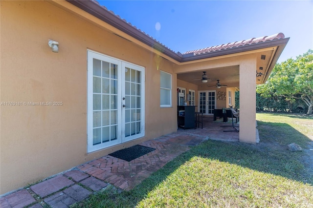 view of patio with french doors and ceiling fan